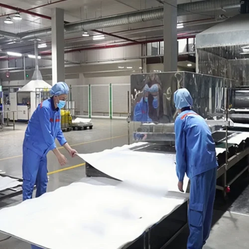 Worker inspecting finished FIBC bulk bags for quality control