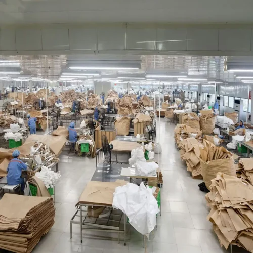 Workers sewing FIBC bulk bags on industrial sewing machines